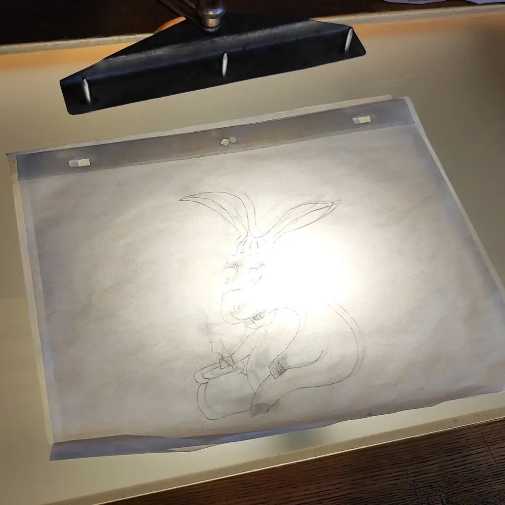 An animation light table with a drawing on it.
