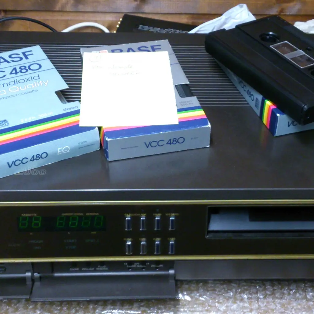 A Grundig Video 2x4 recorder with VHS and video cassettes on top.