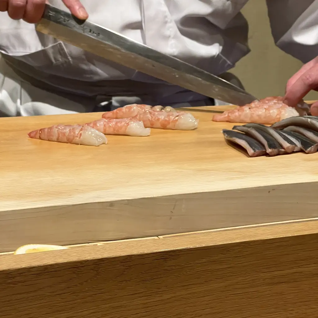 A sushi counter with the chef's station behind it.