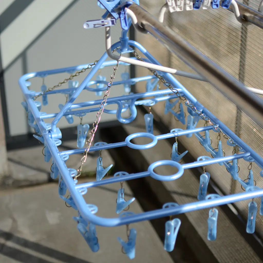 A pinch hanger of laundry drying on a balcony in Japan.