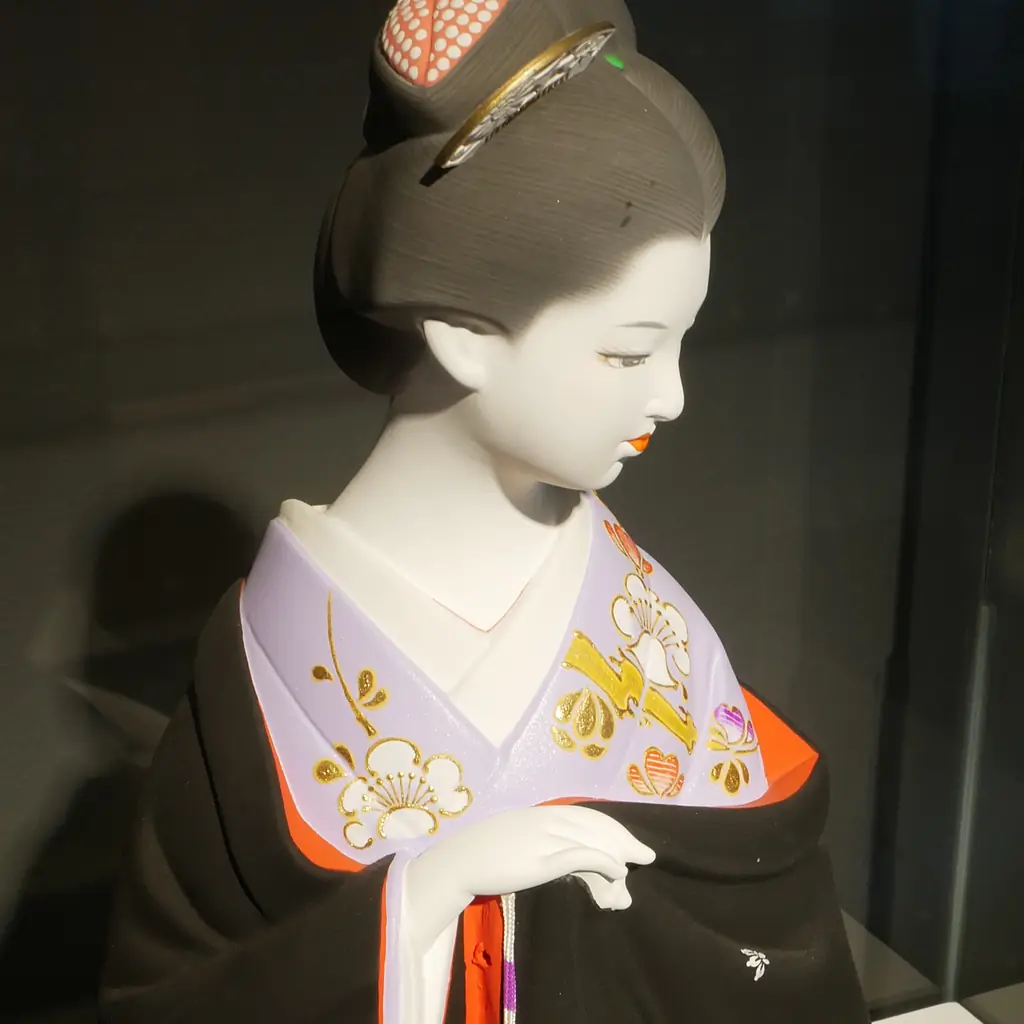 A Hakata doll of a woman in kimono.