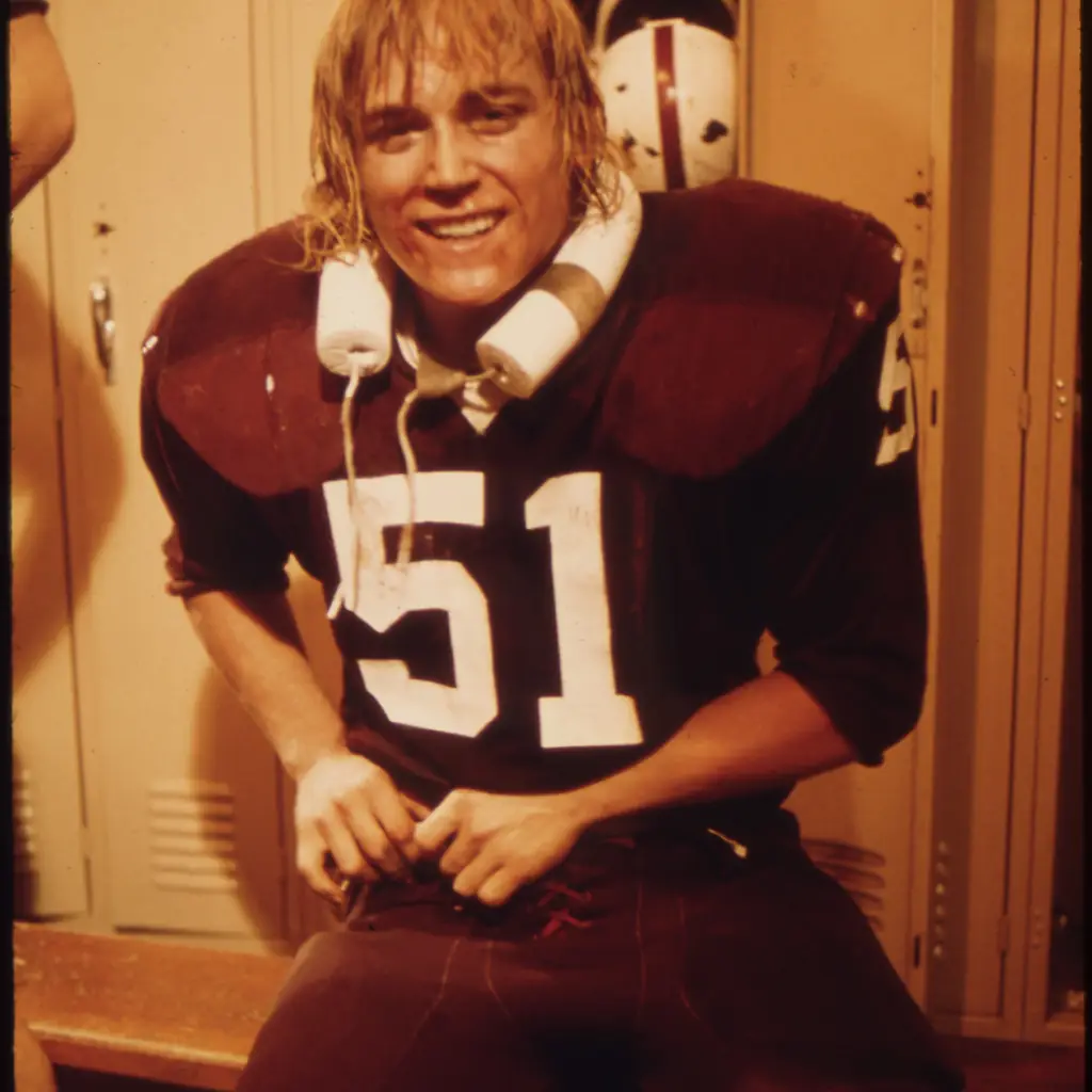 A football player from Cathedral Senior High School in New Ulm, Minnesota, suiting up in the locker room.