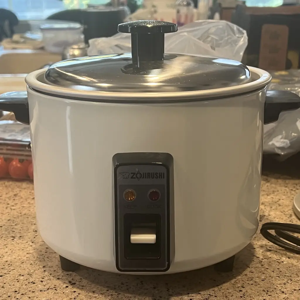 A Zojirushi rice cooker on a kitchen counter.