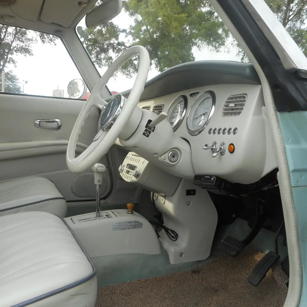 The right-hand-drive interior of a Nissan Figaro.